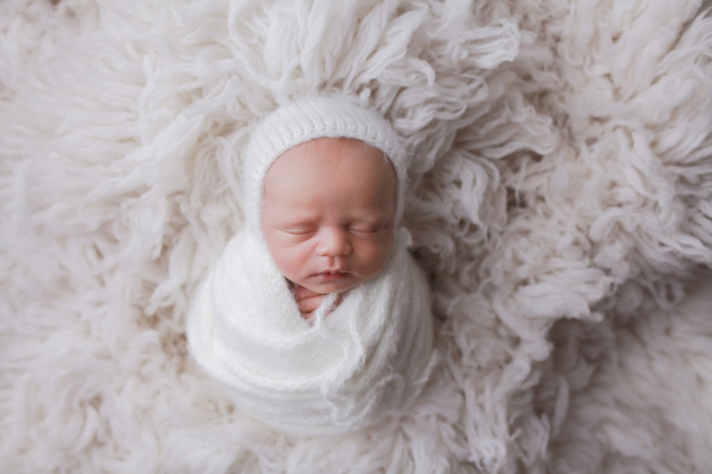 newborn baby boy with a white bonnet, newborn photoshoot, Austin newborn photographer, temple newborn photographer, Georgetown newborn photographer