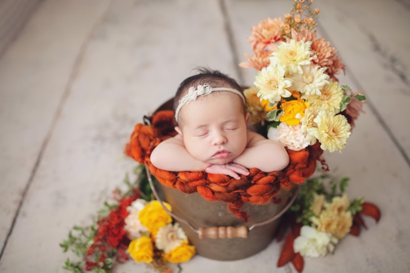 Austin baby inside bucket with flowers, photo of baby