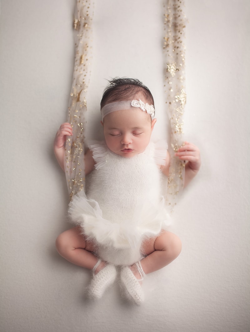 Baby on a ballerina outfit, baby on a swing photo
